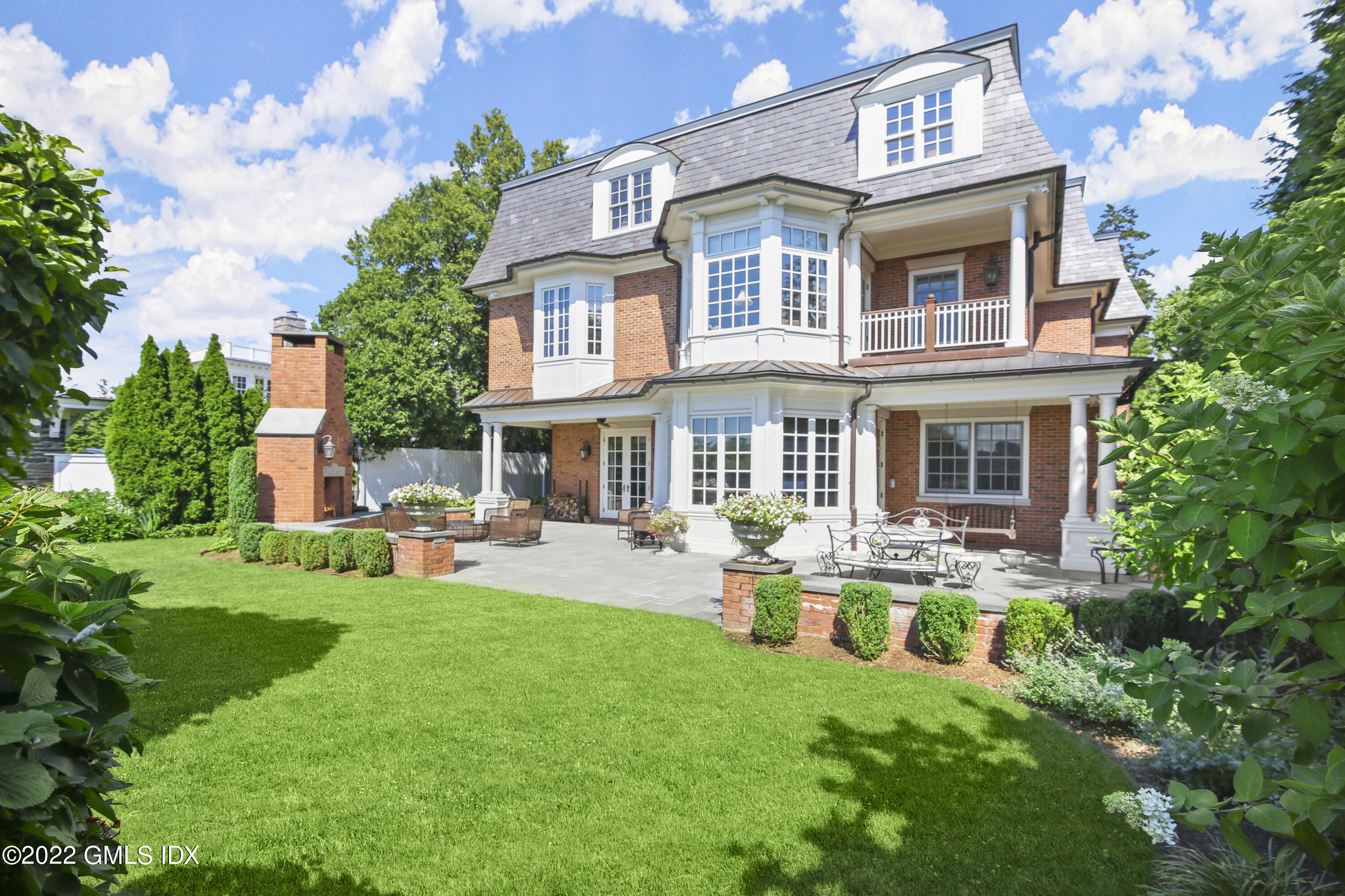 62 Ridge Street Greenwich, CT 06830 - Photo 33 of 40 a front view of house with a garden and patio