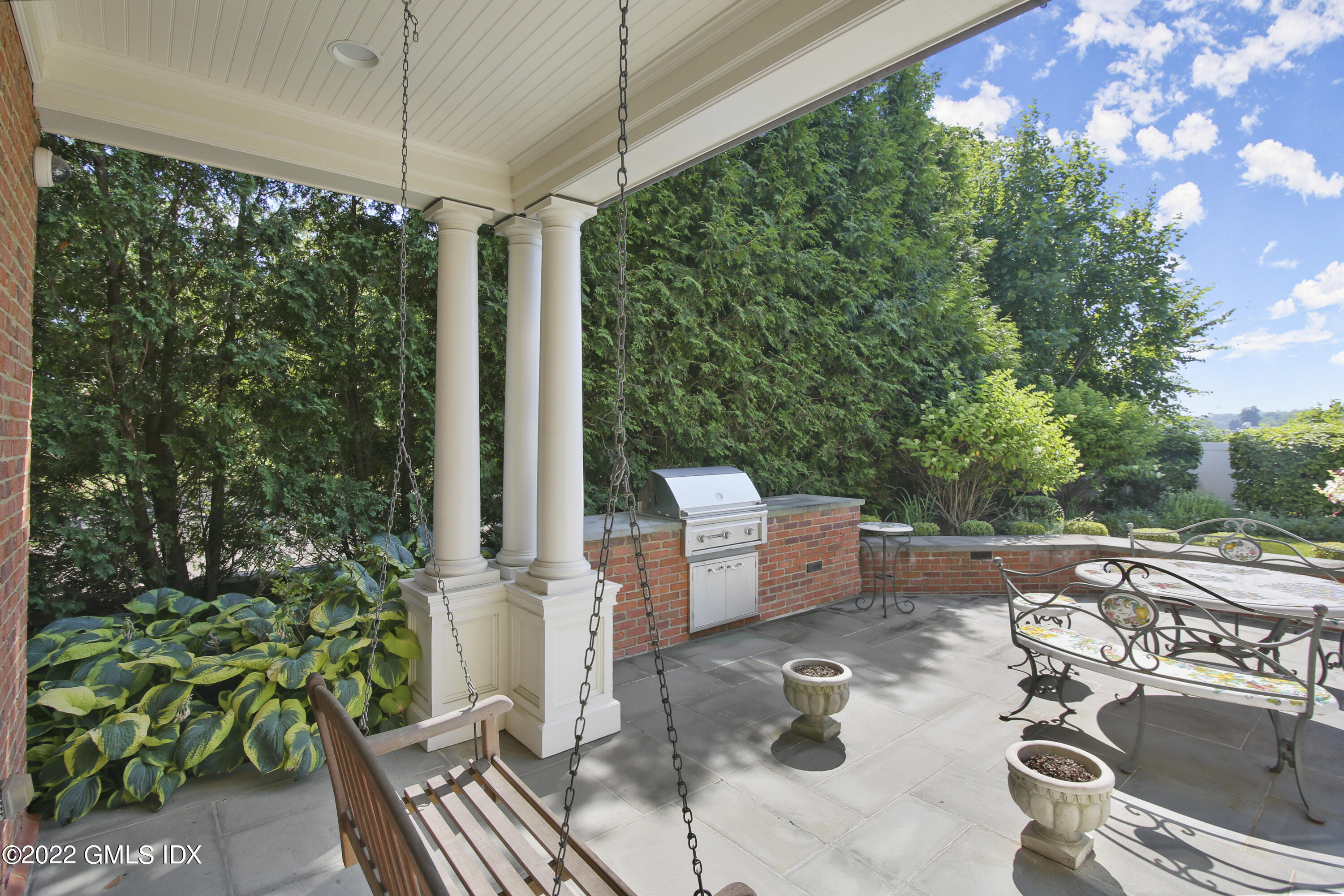 62 Ridge Street Greenwich, CT 06830 - Photo 35 of 40 a view of a patio with table and chairs potted plants with wooden floor and fence