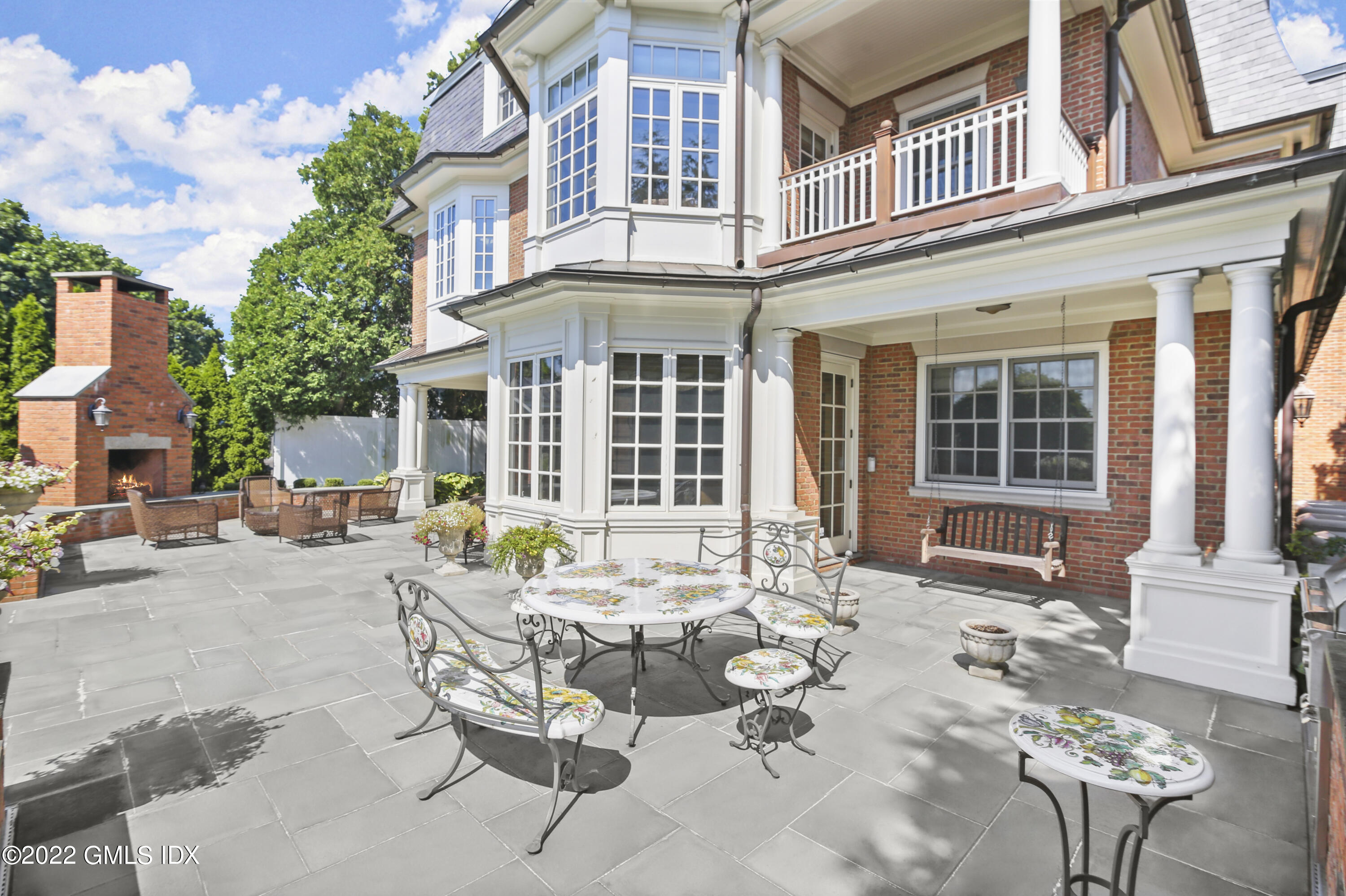 62 Ridge Street Greenwich, CT 06830 - Photo 36 of 40 a view of a patio with couches table and chairs and potted plants