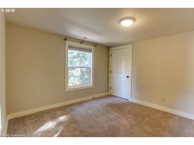 9506 Southwest Boones Ferry Road Portland, OR 97219 - Photo 18 of 32 a view of an empty room with a window