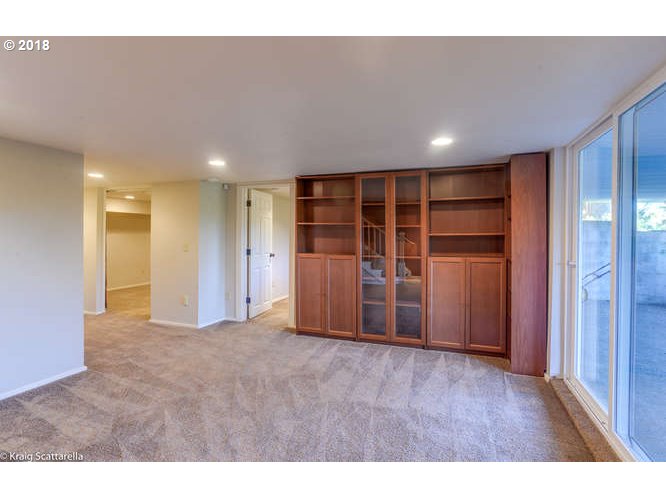 9506 Southwest Boones Ferry Road Portland, OR 97219 - Photo 23 of 32 a view of an empty room with wooden floor