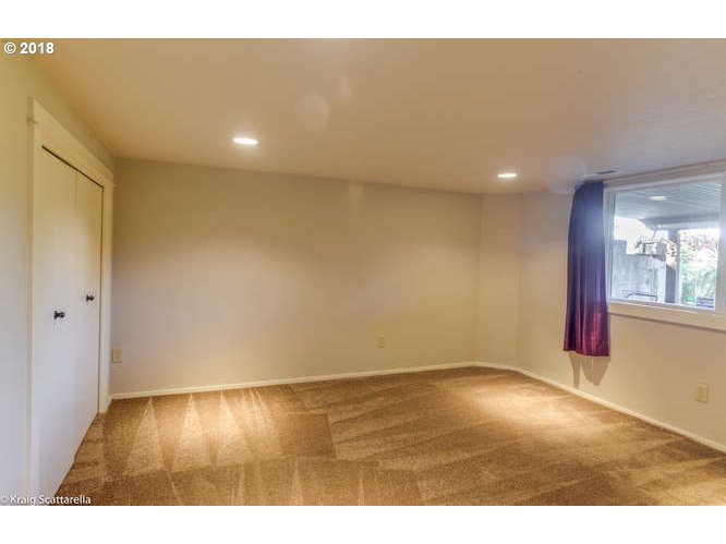 9506 Southwest Boones Ferry Road Portland, OR 97219 - Photo 24 of 32 a view of an empty room with wooden floor