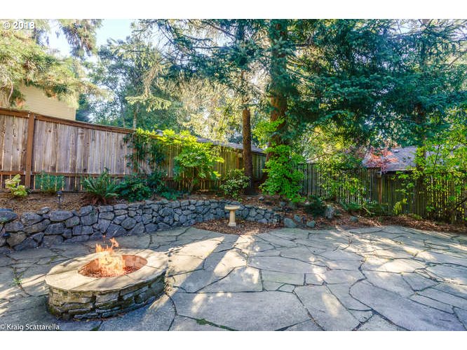 9506 Southwest Boones Ferry Road Portland, OR 97219 - Photo 28 of 32 a backyard of a house with yard and outdoor seating