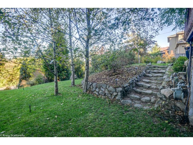 9506 Southwest Boones Ferry Road Portland, OR 97219 - Photo 29 of 32 a view of a yard with a tree