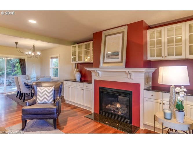 9506 Southwest Boones Ferry Road Portland, OR 97219 - Photo 4 of 32 a living room with furniture a fireplace and a table