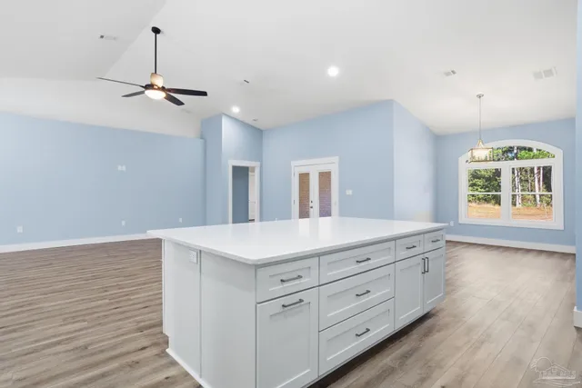 a view of a kitchen with a sink and refrigerator