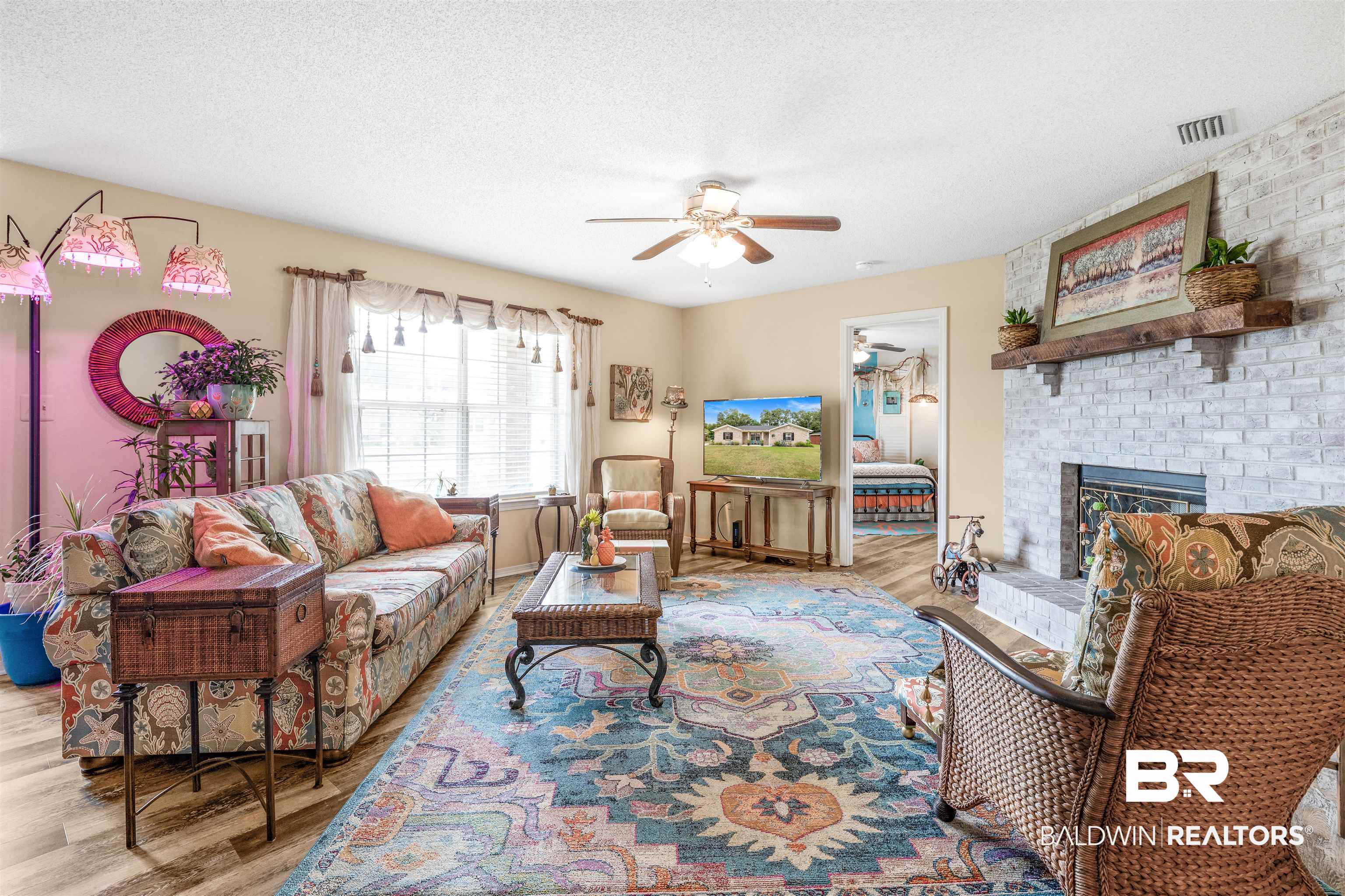 518 Ariel Avenue Foley, AL 36535 - Photo 6 of 47 Living room featuring a fireplace, a textured ceiling, light hardwood / wood-style flooring, and ceiling fan