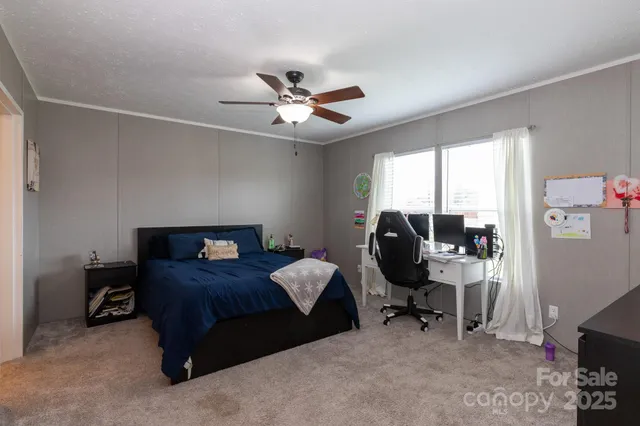a bedroom with a bed a desk and chair