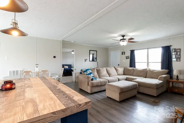 a living room with furniture and a chandelier