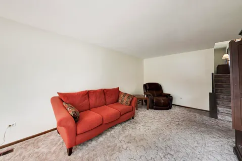 a living room with furniture a couch and a flat screen tv