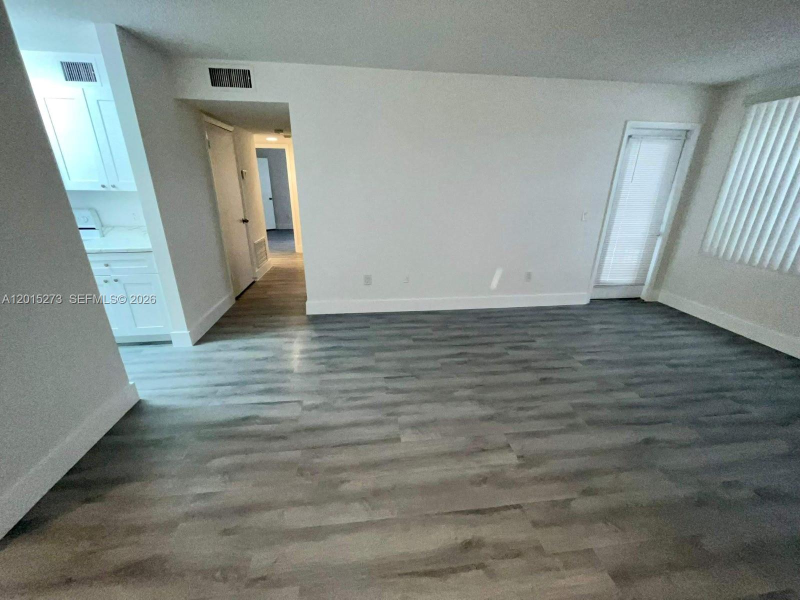 4561 West McNab Road, Unit 17 Pompano Beach, FL 33069 - Photo 2 of 11 a view of a hallway with wooden floor