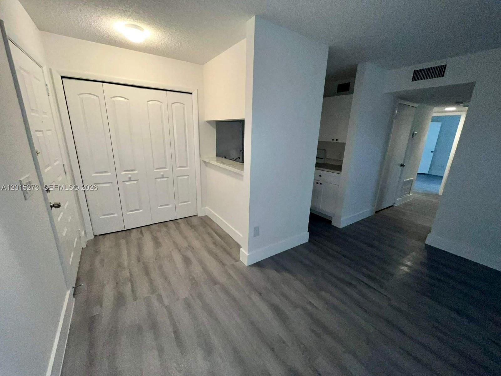 4561 West McNab Road, Unit 17 Pompano Beach, FL 33069 - Photo 3 of 11 a view of hallway with wooden floor