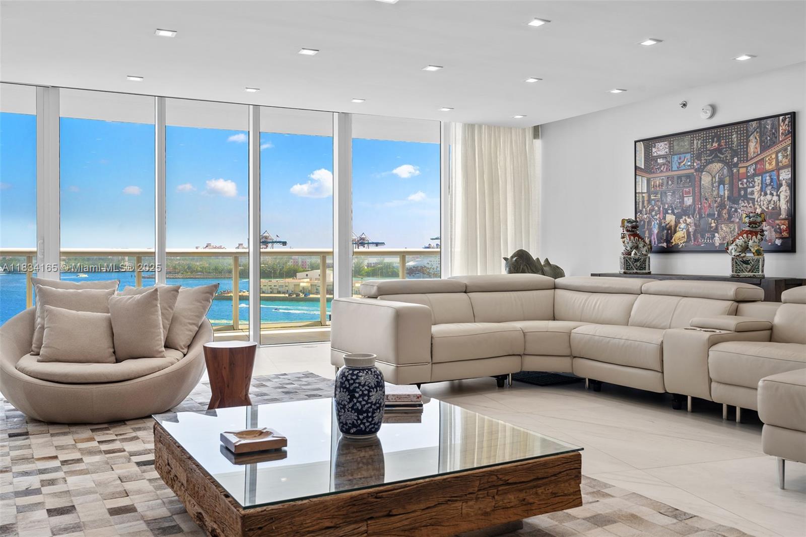 450 Alton Road, Unit 901902 Miami Beach, FL 33139 - Photo 11 of 100 a living room with furniture and a large window