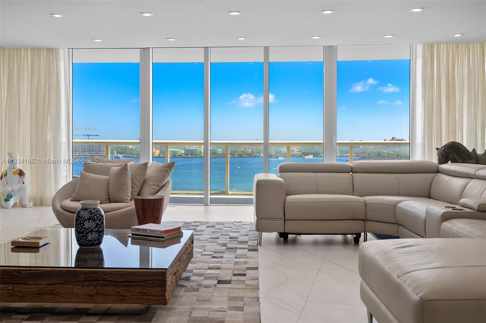 450 Alton Road, Unit 901902 Miami Beach, FL 33139 - Photo 23 of 100 a living room with furniture kitchen view and large windows