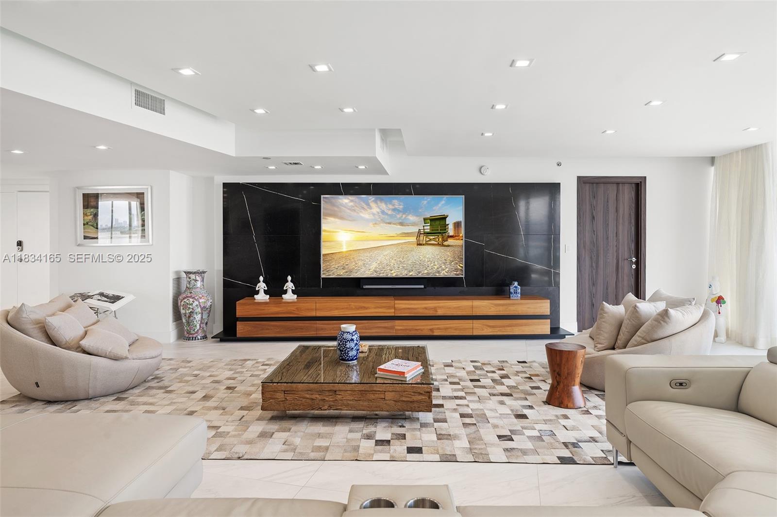 450 Alton Road, Unit 901902 Miami Beach, FL 33139 - Photo 3 of 100 a living room with furniture and a flat screen tv