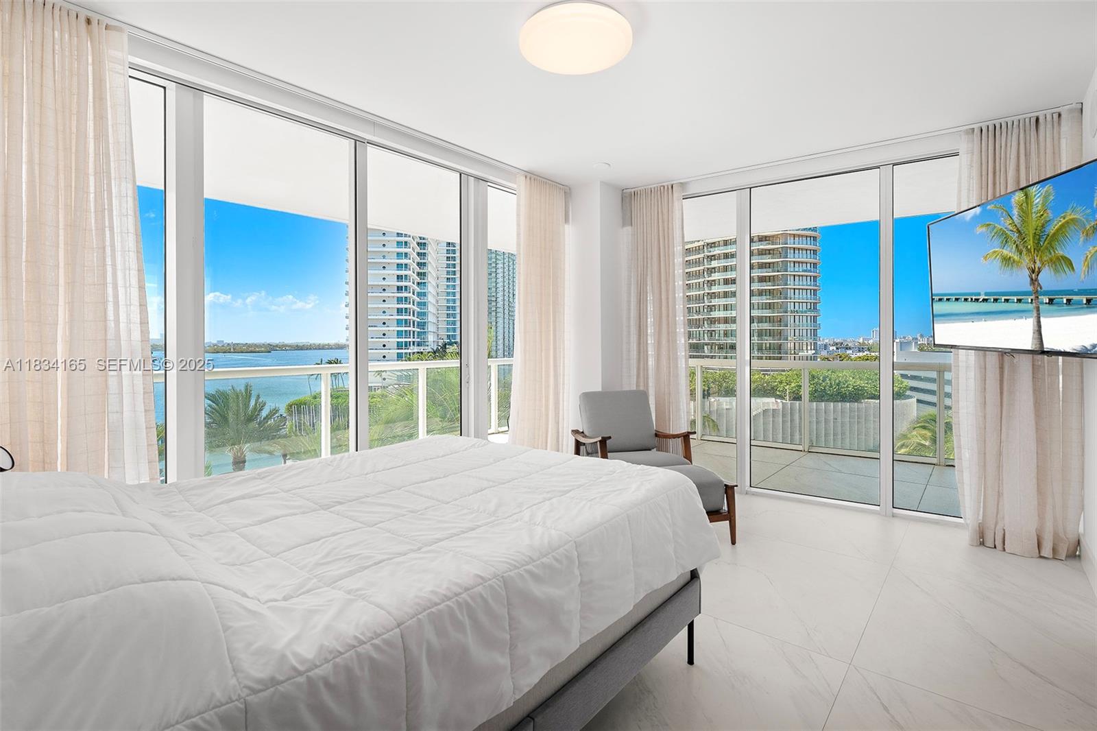 450 Alton Road, Unit 901902 Miami Beach, FL 33139 - Photo 44 of 100 a large bed sitting in a bedroom next to a window
