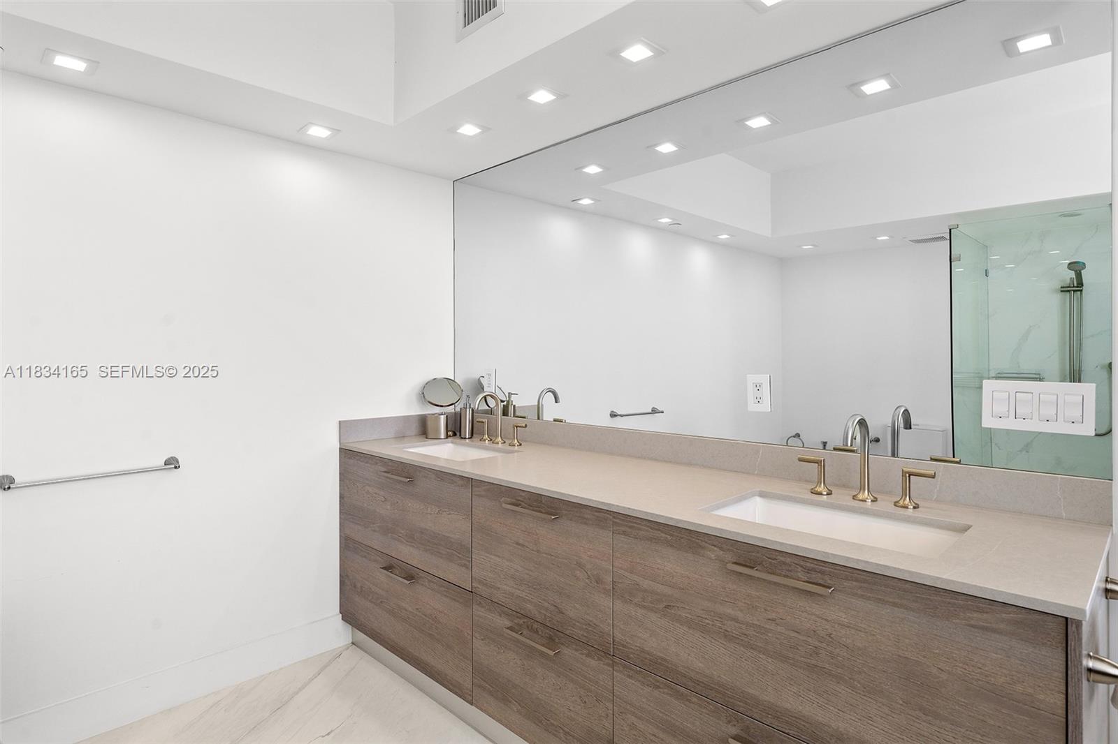 450 Alton Road, Unit 901902 Miami Beach, FL 33139 - Photo 46 of 100 a bathroom with a double vanity sink and a mirror