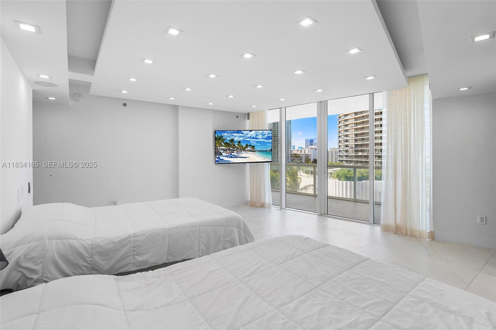450 Alton Road, Unit 901902 Miami Beach, FL 33139 - Photo 51 of 100 a large bedroom with a large bed and a view of bathroom