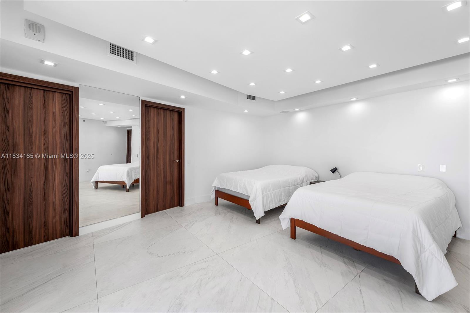 450 Alton Road, Unit 901902 Miami Beach, FL 33139 - Photo 53 of 100 a spacious bedroom with a bed and window