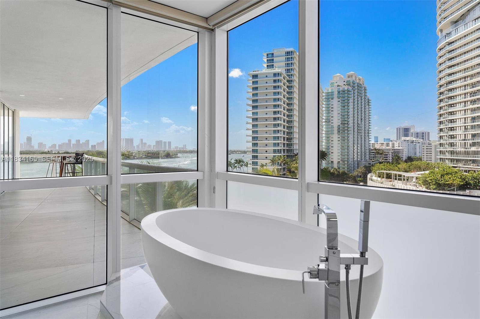 450 Alton Road, Unit 901902 Miami Beach, FL 33139 - Photo 56 of 100 a white bath tub sitting in front of a window