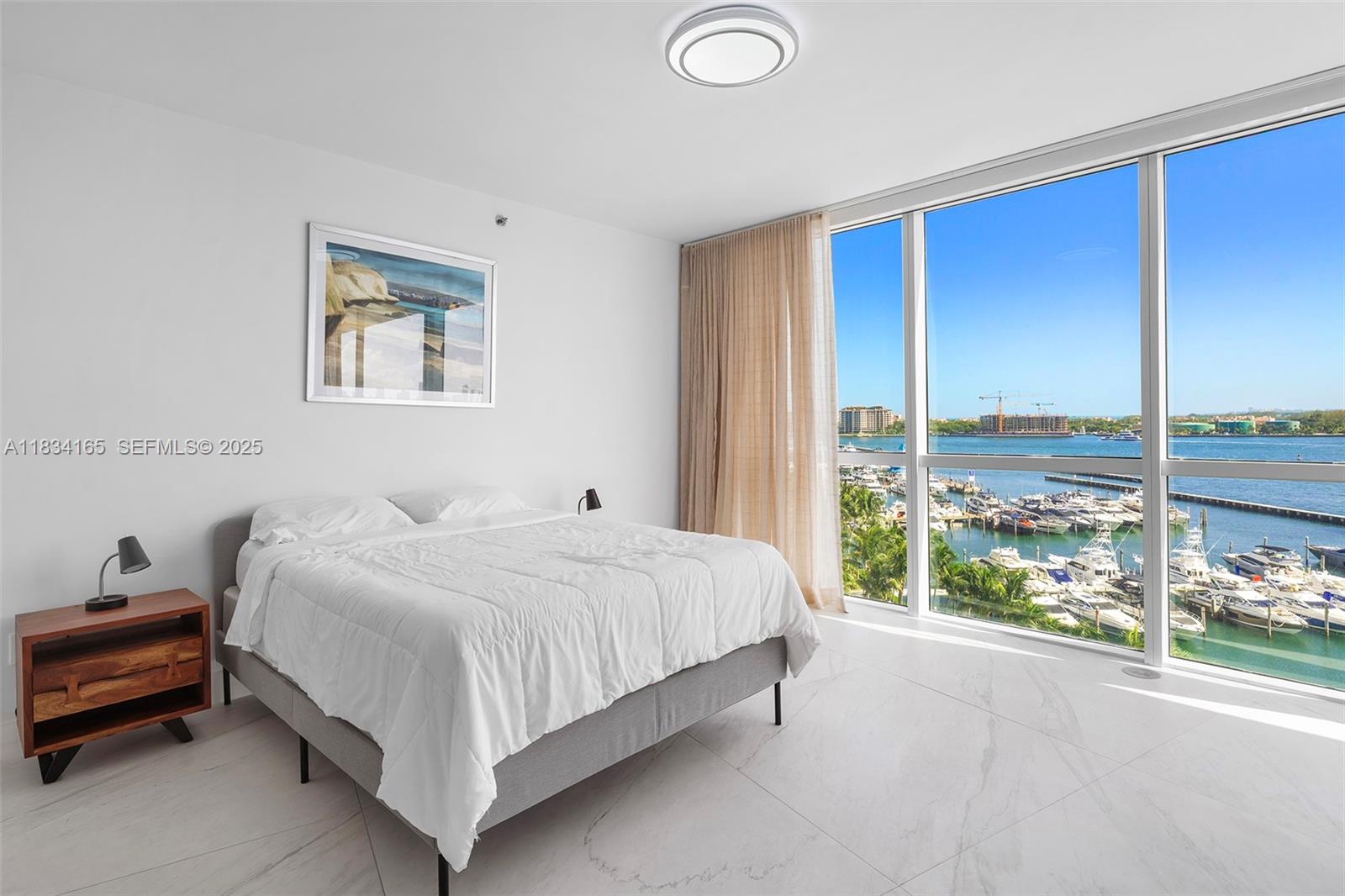 450 Alton Road, Unit 901902 Miami Beach, FL 33139 - Photo 60 of 100 a bedroom with a bed and a large window