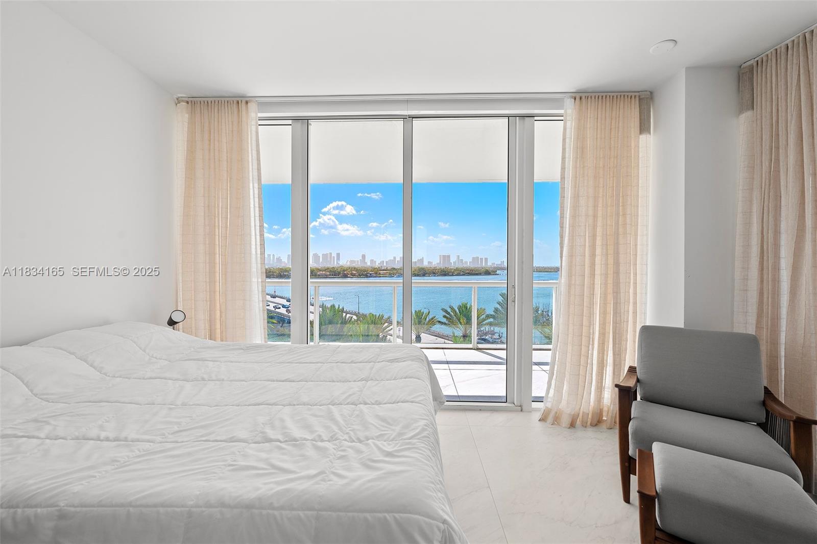 450 Alton Road, Unit 901902 Miami Beach, FL 33139 - Photo 66 of 100 a bedroom with a bed and a large window