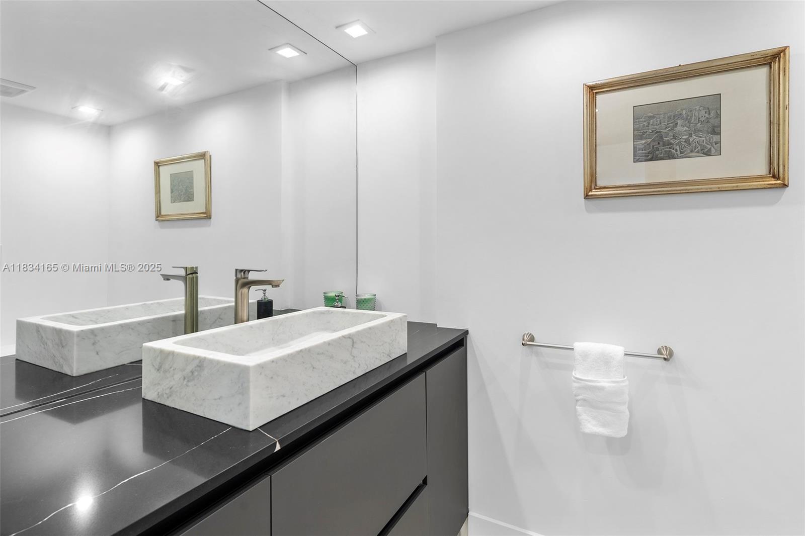 450 Alton Road, Unit 901902 Miami Beach, FL 33139 - Photo 67 of 100 a bathroom with a sink a toilet and mirror