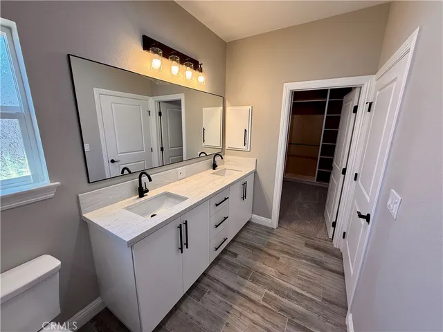 a spacious bathroom with a double vanity sink and mirror