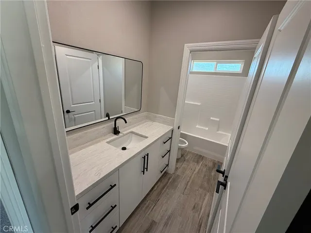 a bathroom with a sink a mirror and a shower