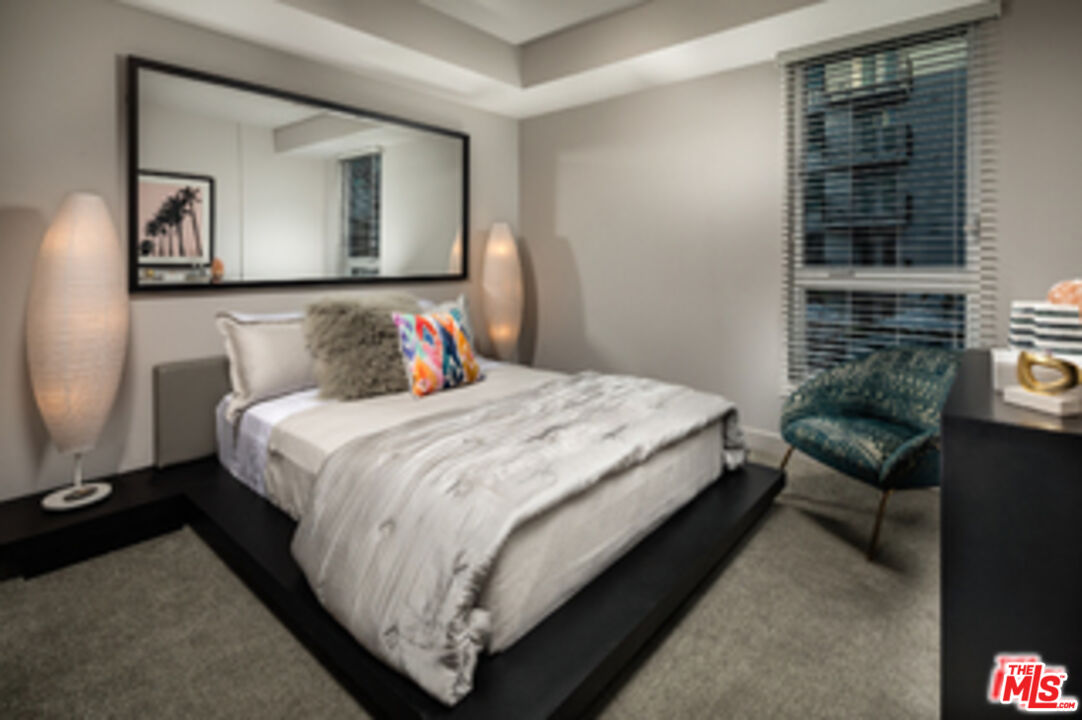 687 South Hobart Boulevard, Unit 327 Los Angeles, CA 90005 - Photo 17 of 21 a bedroom with bed and a night stand