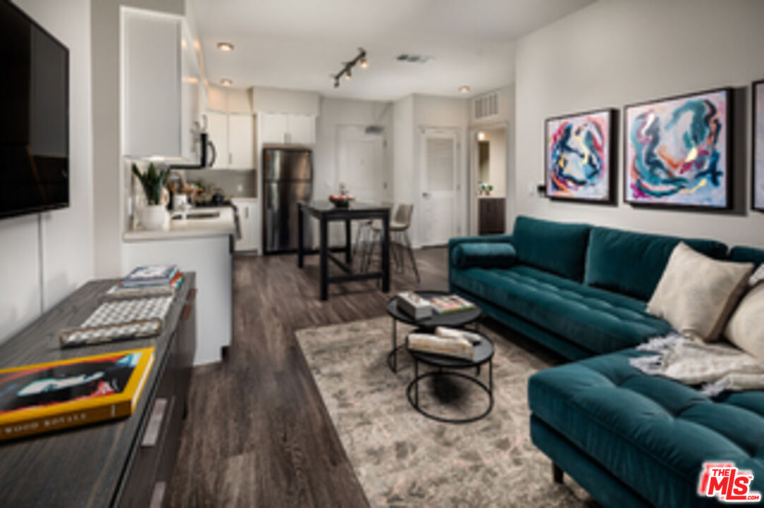 687 South Hobart Boulevard, Unit 327 Los Angeles, CA 90005 - Photo 19 of 21 a living room with furniture and a flat screen tv