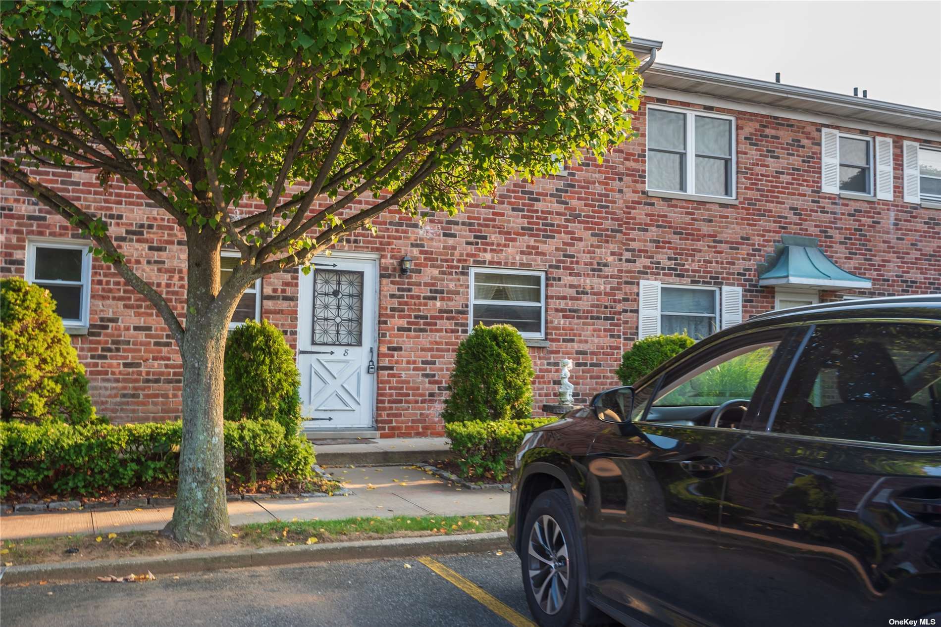 a front view of house with car parked