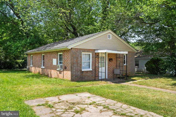 a front view of a house with a yard and porch