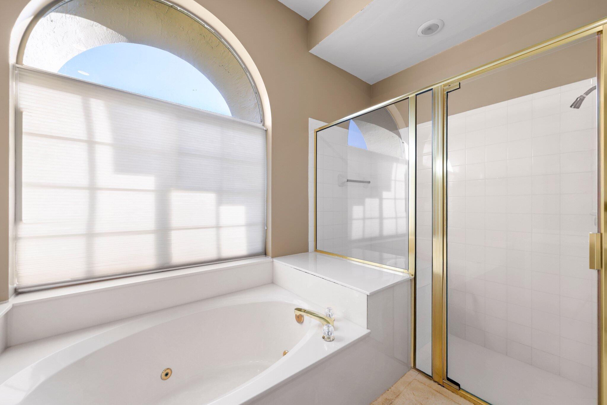 2595 Northwest 53rd Street Boca Raton, FL 33496 - Photo 12 of 48 a bathroom with a bathtub and a shower