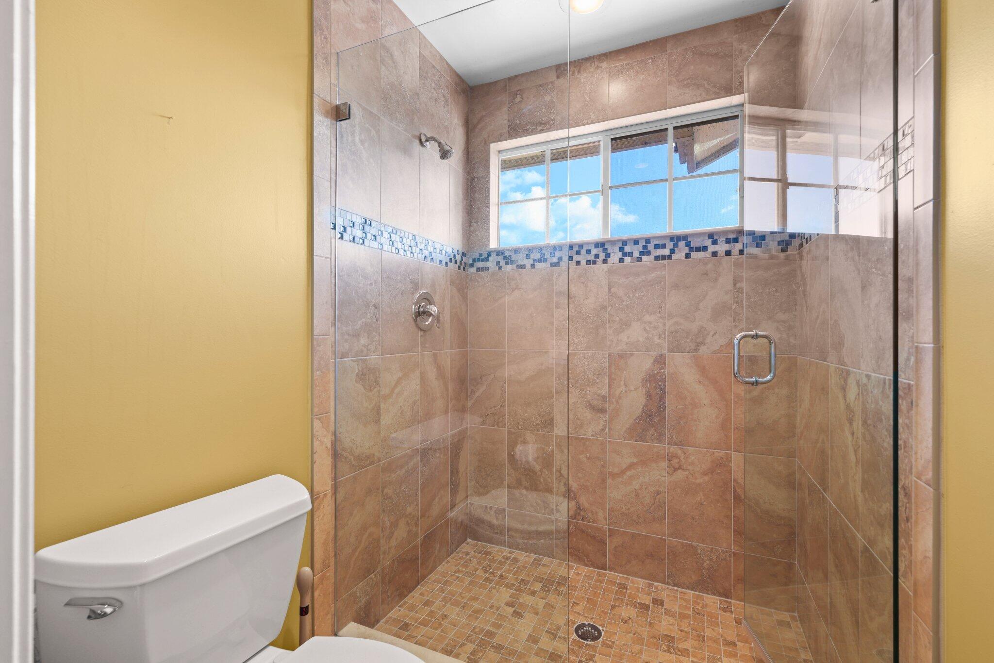 2595 Northwest 53rd Street Boca Raton, FL 33496 - Photo 18 of 48 a bathroom with a shower and a toilet