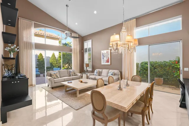 a dining room with furniture a large window and a rug