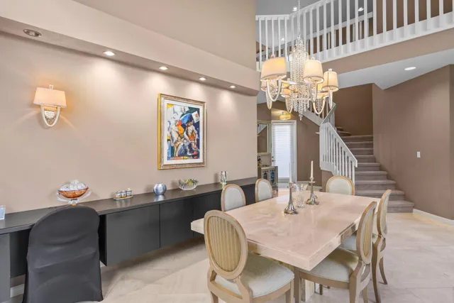 a view of a dining room with furniture and chandelier