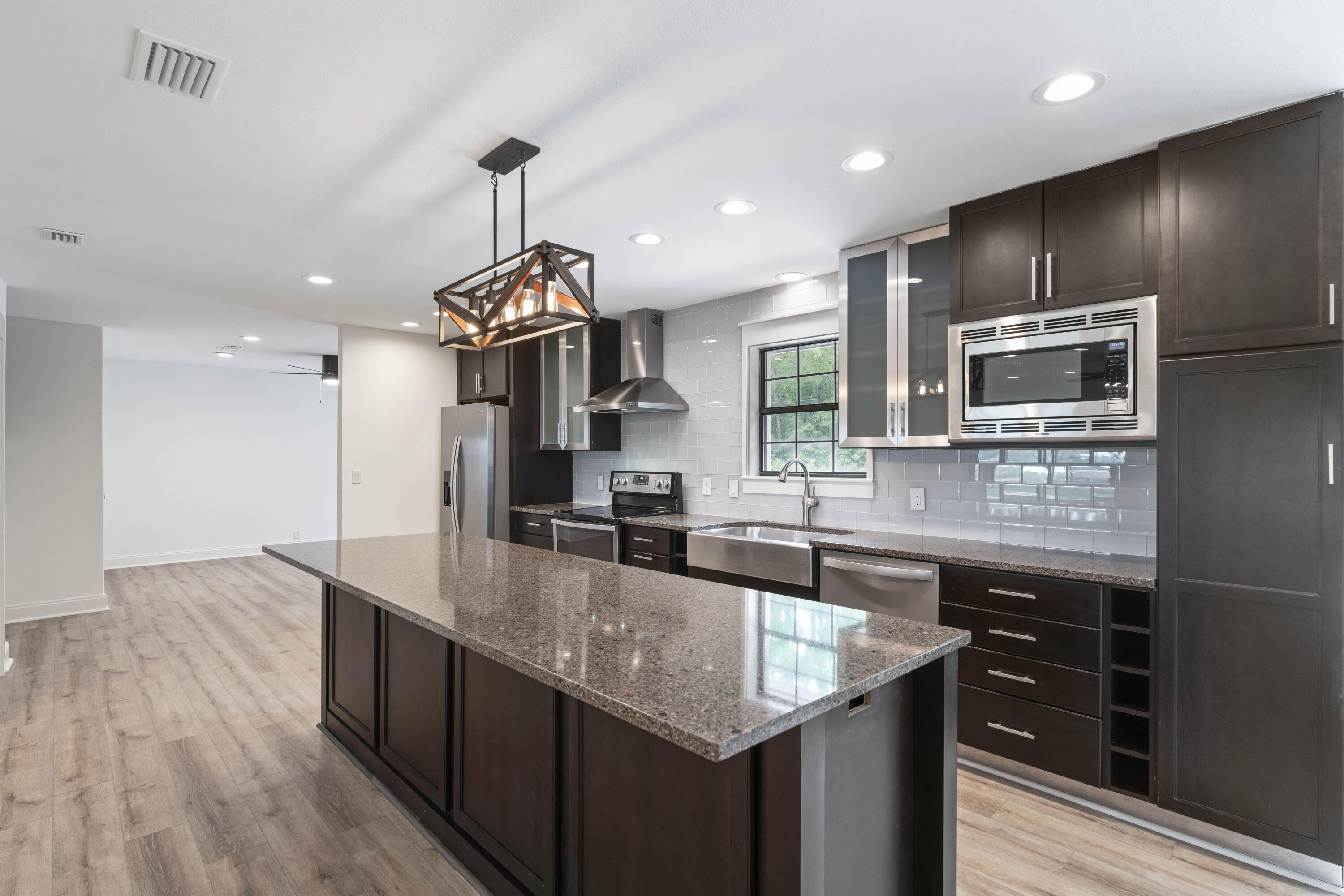 1534 Bay Grove Road Freeport, FL 32439 - Photo 12 of 33 a kitchen with stainless steel appliances granite countertop a sink a stove and a wooden floors