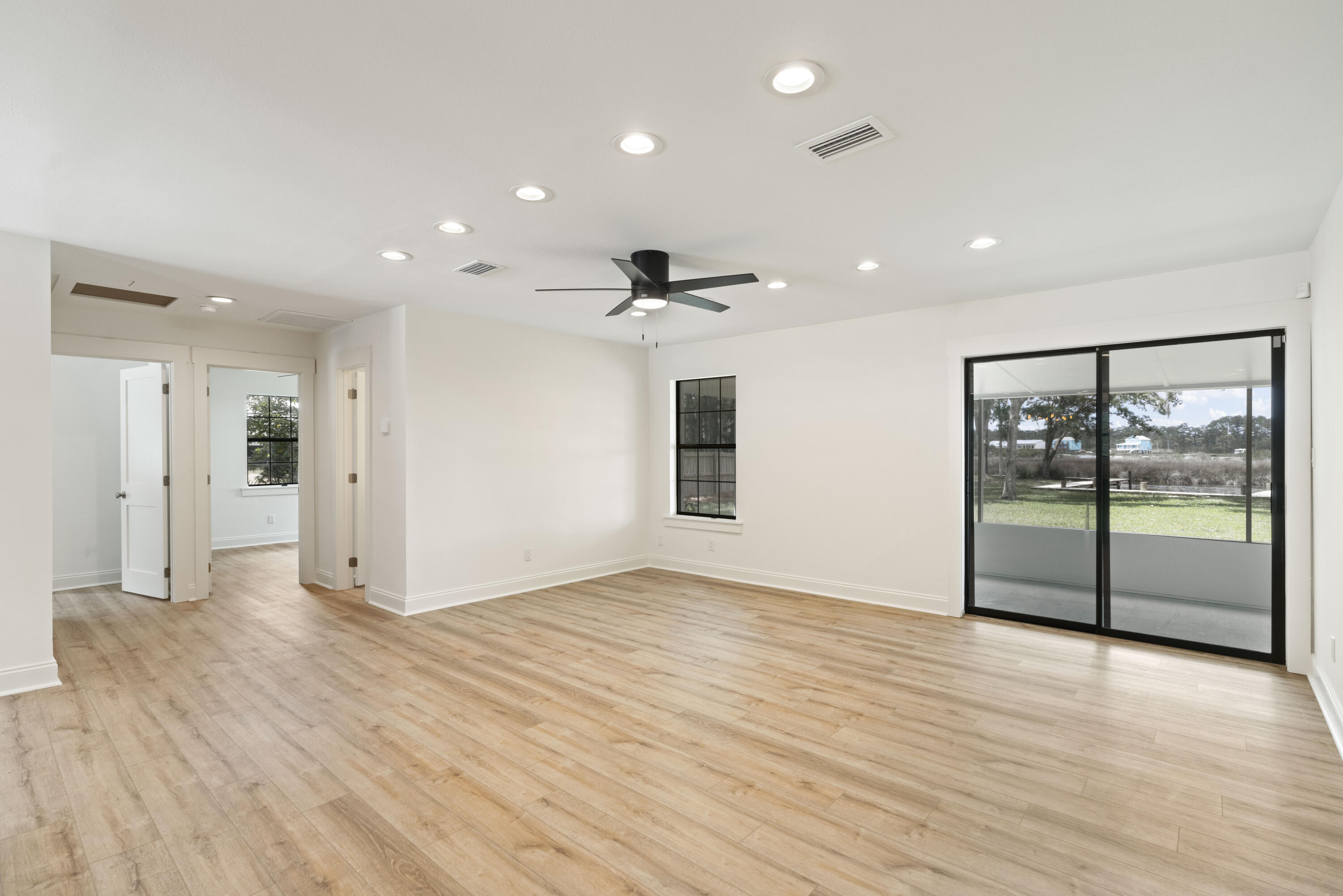 1534 Bay Grove Road Freeport, FL 32439 - Photo 15 of 33 an empty room with wooden floor and windows
