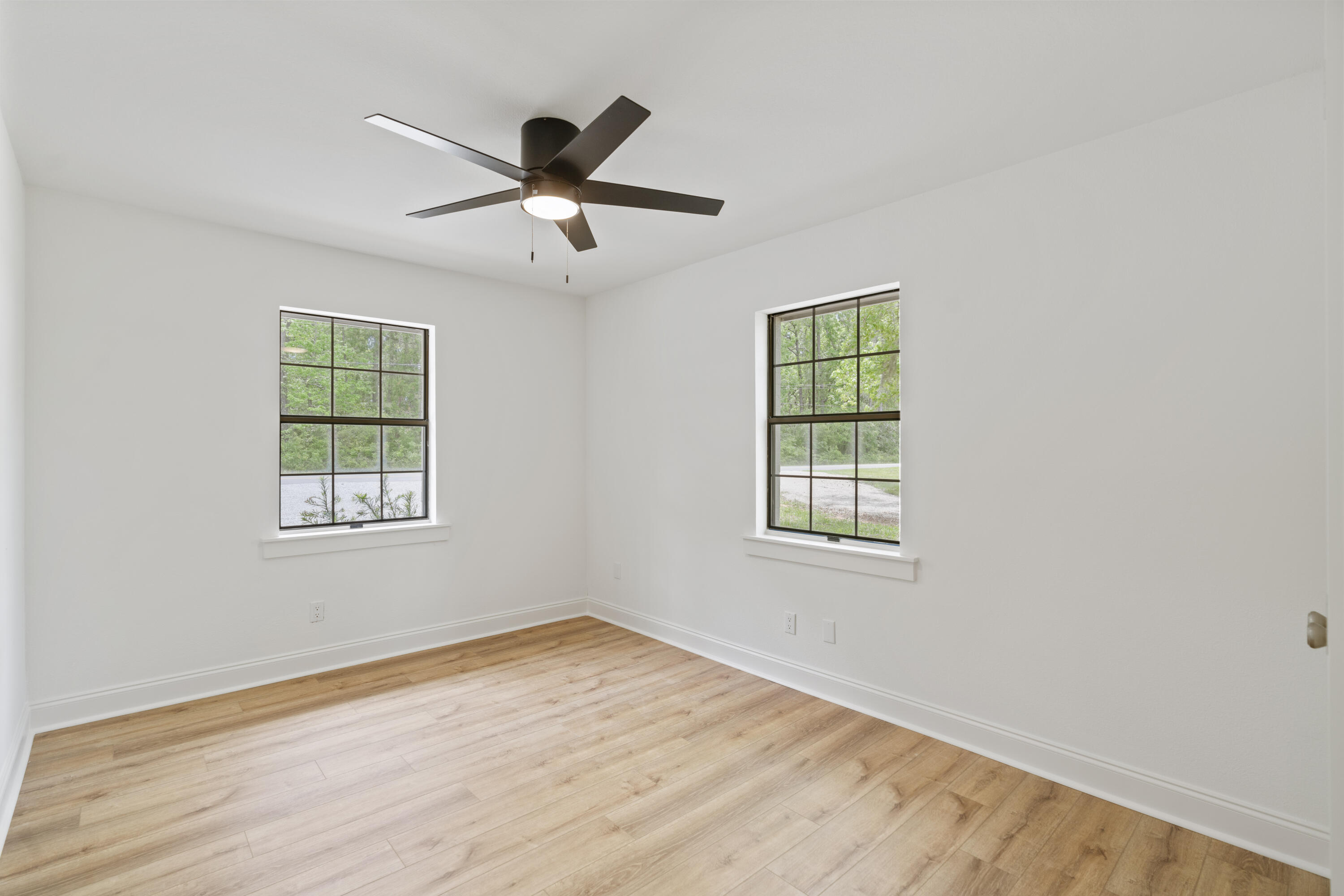 1534 Bay Grove Road Freeport, FL 32439 - Photo 18 of 33 a view of an empty room with wooden floor and a window