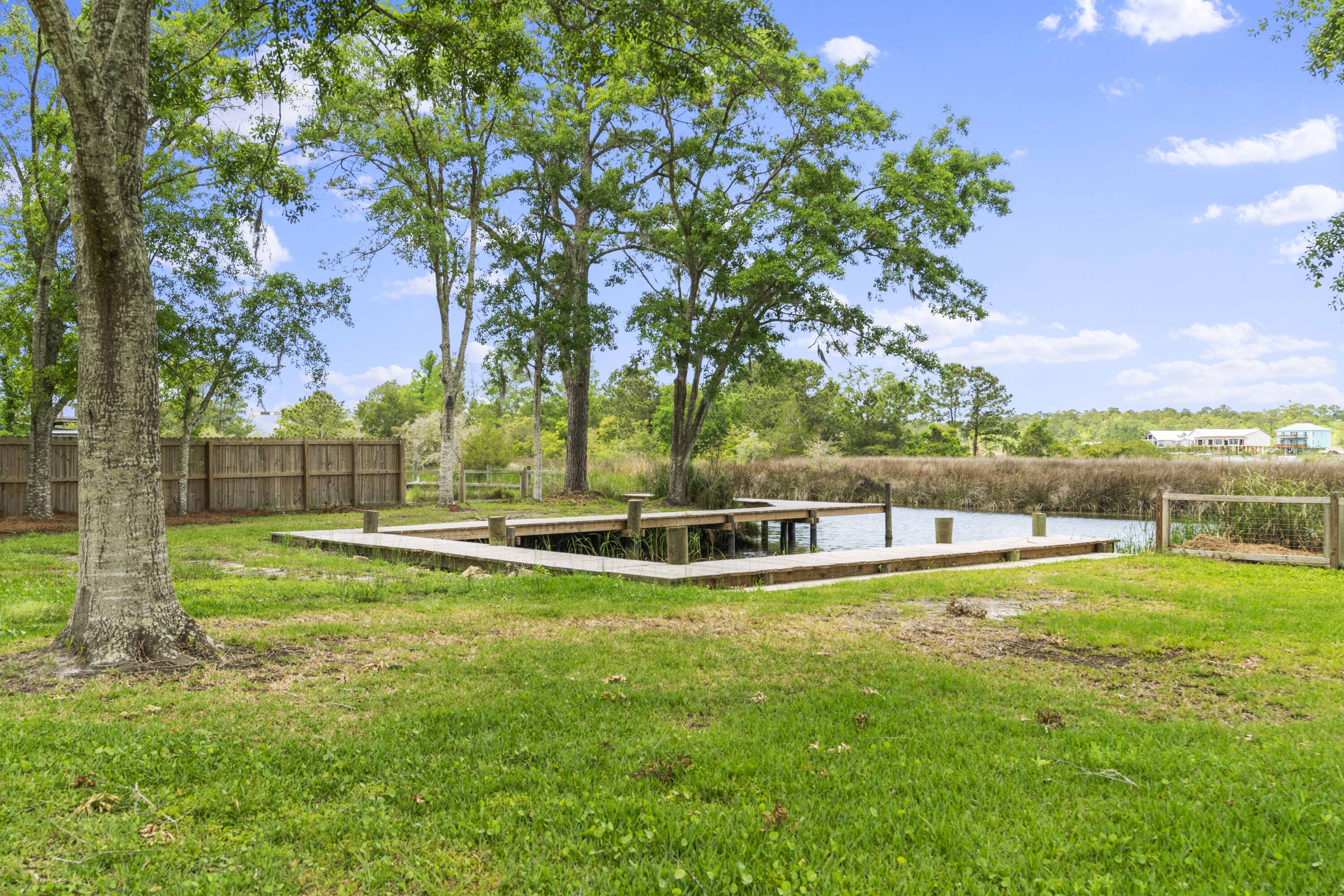 1534 Bay Grove Road Freeport, FL 32439 - Photo 23 of 33 a view of a swimming pool with lawn chairs and a big yard