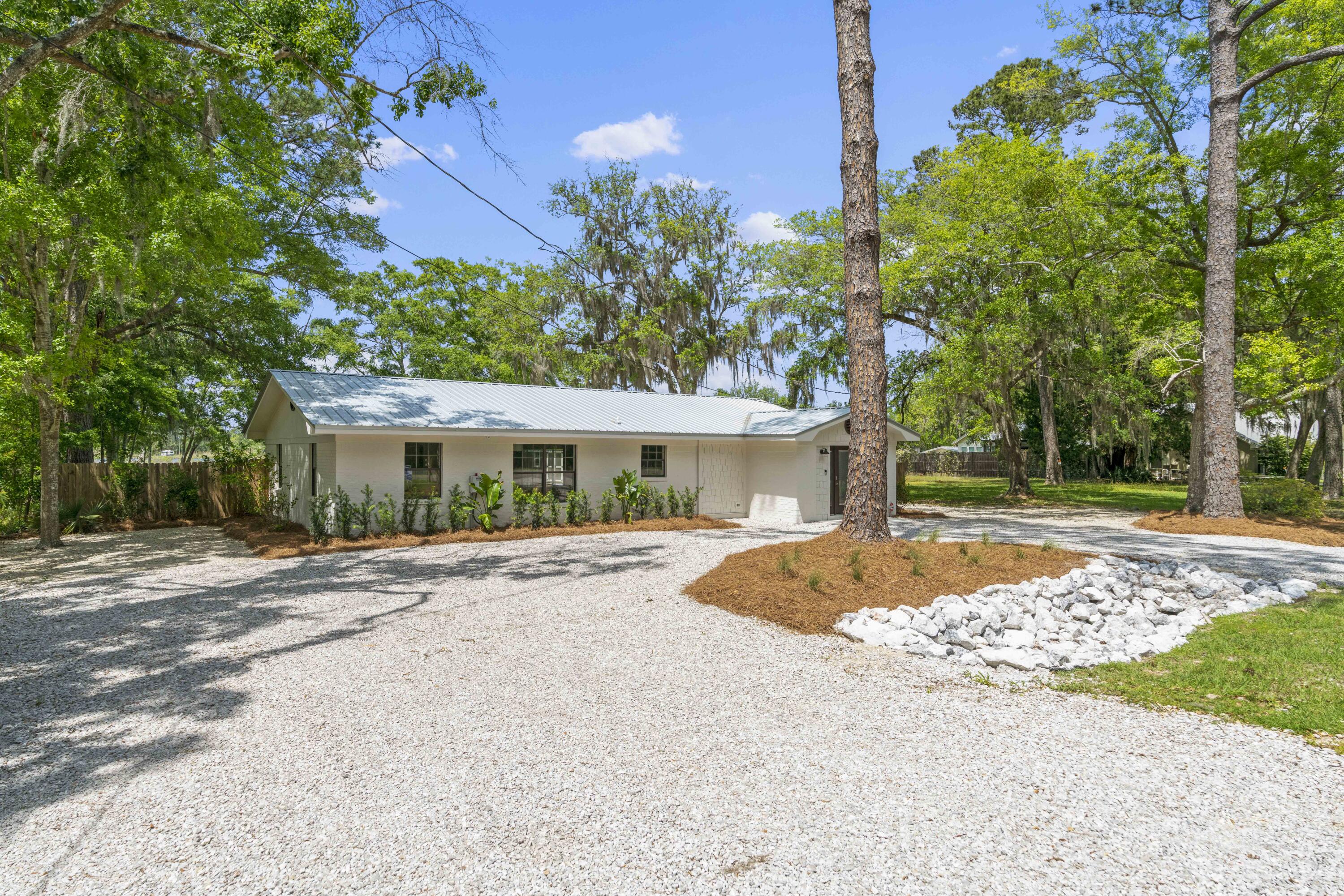 1534 Bay Grove Road Freeport, FL 32439 - Photo 33 of 33 a front view of a house with a yard and a garage