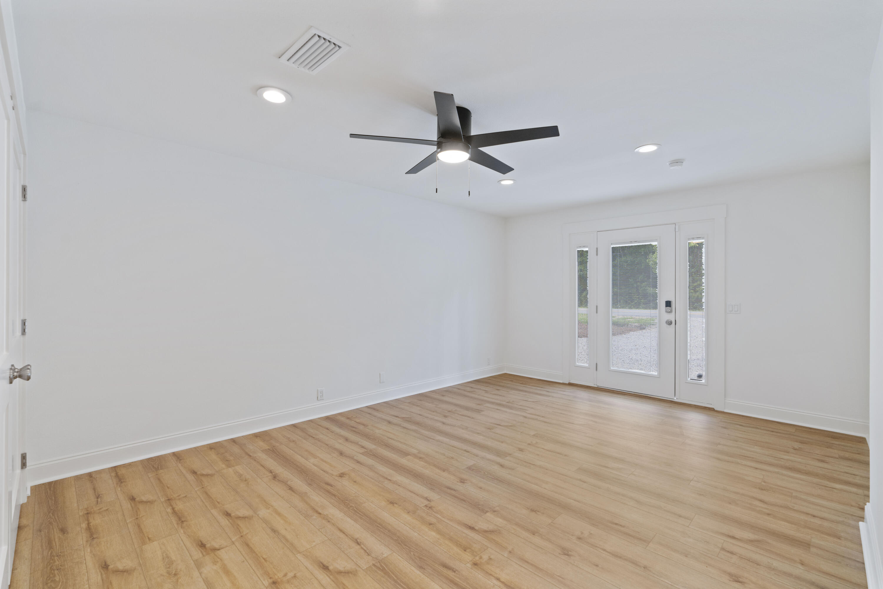 1534 Bay Grove Road Freeport, FL 32439 - Photo 4 of 33 wooden floor in an empty room with a window