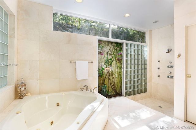 a bathroom with a bathtub and a shower