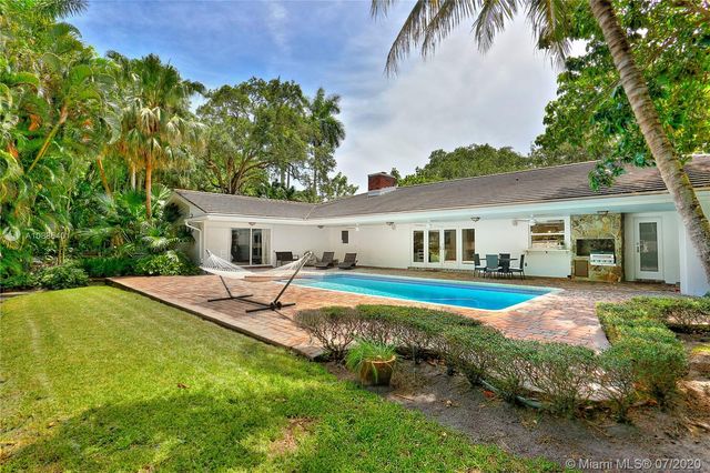 a view of a house with swimming pool and a yard