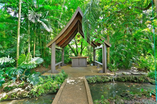 a backyard of a house with lots of green space and plants