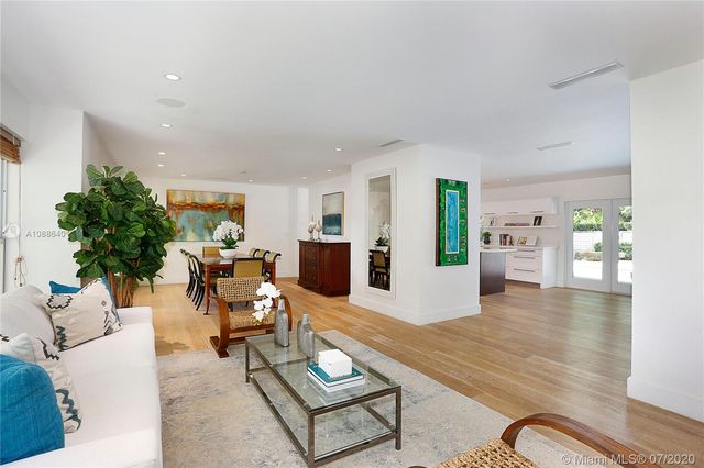 a living room with furniture kitchen view and a table