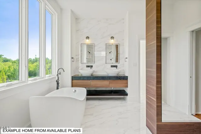 an empty room with wooden floor fireplace and windows