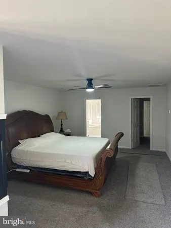 a spacious bathroom with a granite countertop tub sink and mirror