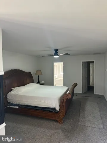 a spacious bathroom with a granite countertop tub sink and mirror